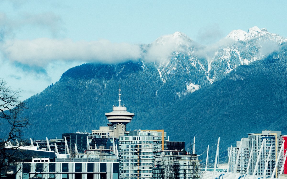 The Vancouver skyline with Harbour Centre and the snow-covered North Shore mountains behind it